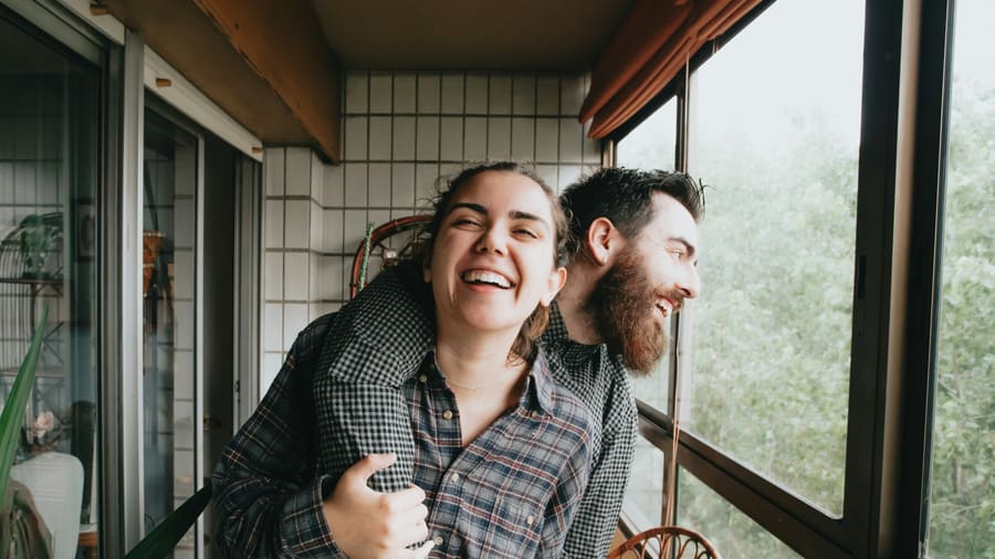 A smiling woman sharing a relaxed moment with a kind companion.