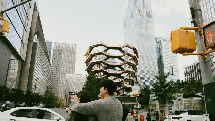 A woman and her companion enjoying time together in a city setting.