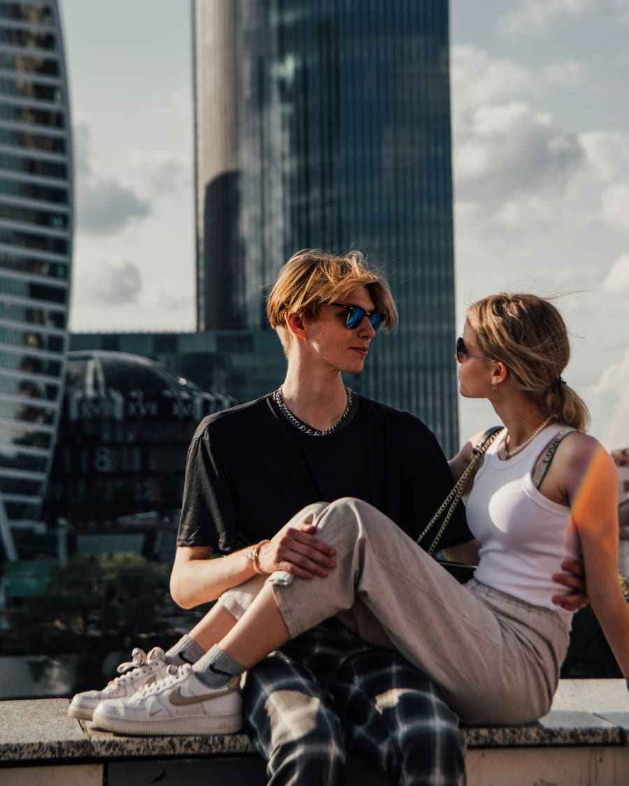 A woman and her companion enjoying time together in a city setting.